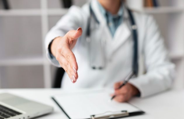 close-up-doctor-waiting-shake-patients-hand (1)